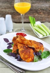 Crisp crunchy golden chicken legs with basil and tomato sauce