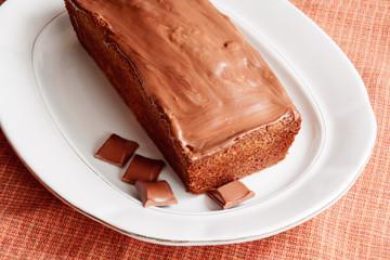 Cake with glaze of chocolate in the white dish