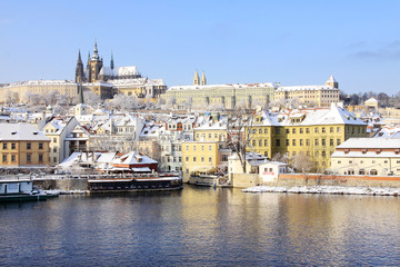 Fototapeta premium Snowy Prague gothic Castle above River Vltava