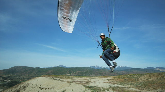 WS PAN POV Man Paragliding Over Mountain / Lehi, Utah, USA.