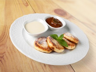 Closeup. Cottage cheese pancake with sour cream and syrup