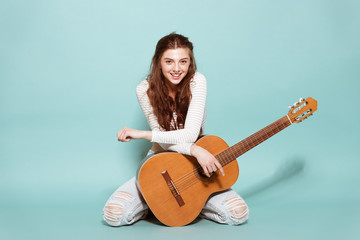 beautiful young girl posing with guitar