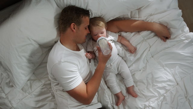 father and baby lying down