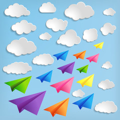 Fototapeta na wymiar Paper airplanes with clouds on blue background