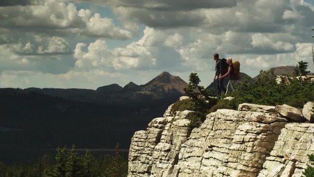 WS Hikers looking at view from edge of cliff overlooking valley, Uinta Mountains, Utah, USA