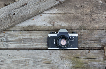 Old retro camera on vintage wooden boards.