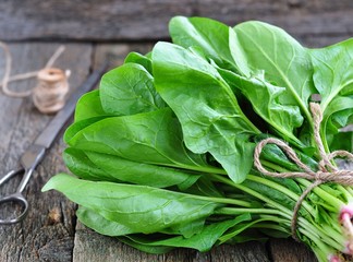 Fresh harvested spinach, on a old wooden table