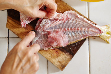 Raw fish being peel