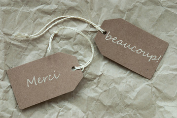 Two Labels Merci Beau Means Thank Paper Background