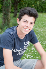 Teenager boy is posing outside in the garden