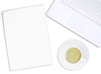 White laptop with paper and coffee cup, top view
