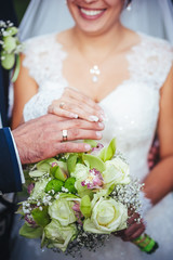 Obraz na płótnie Canvas Bride and groom holding bridal bouquet close up