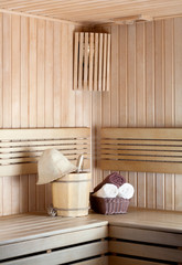 Fototapeta na wymiar Traditional wooden sauna for relaxation with bucket of water and