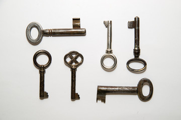 Six old  keys to the safe on a white background