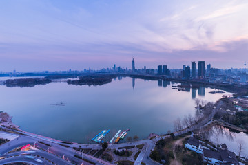 Naklejka premium modern nanjing city skyline with the beautiful lake at night