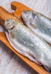 Fresh fish trout on the kitchen board