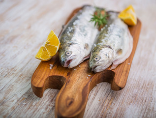 Fresh fish trout on the kitchen board