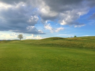 On a empty golf course at sunset