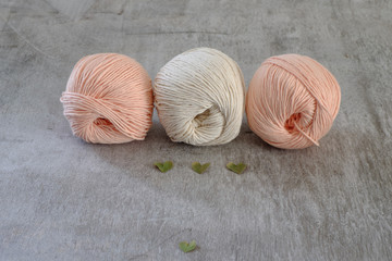 Ball of cream and blue yarn with crochet hook