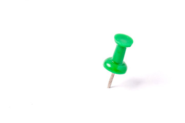 close up of a green pushpin on white background