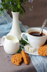 me-nots, a cup of coffee and oatmeal cookies.