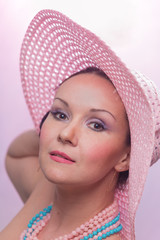 The beautiful woman in a pink hat