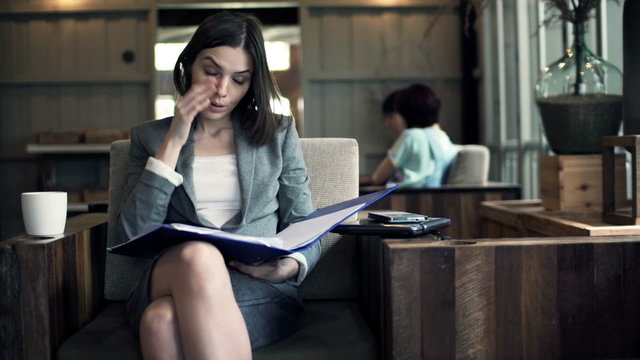 businesswoman having headache during work over documents