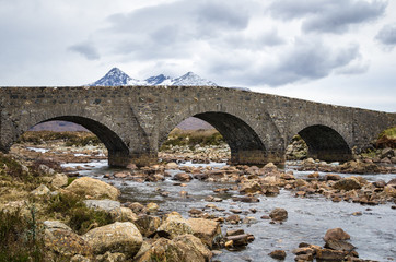 Fototapeta na wymiar Old Stone Bridge on a Winter Cloudy Day, Isle of Skye, Scotland