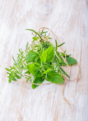 Fresh herbs on a white wooden table