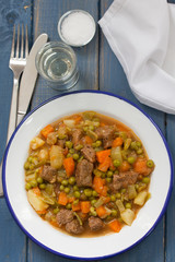meat with carrot, peas and potato on dish