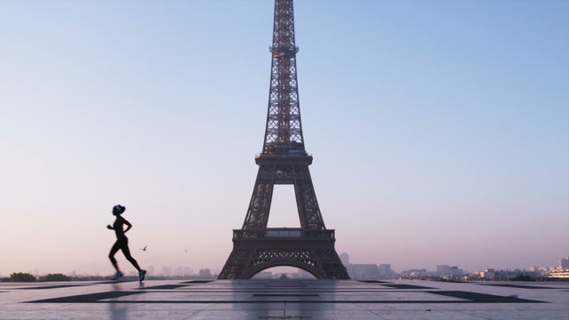 woman running in front of the Eiffel tower