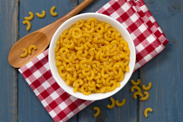dry pasta in white bowl and spoon
