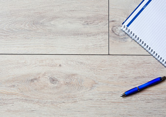 Office table with laptop, phone, notebook and coffee cup