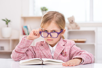 Little cute girl playing role of business woman