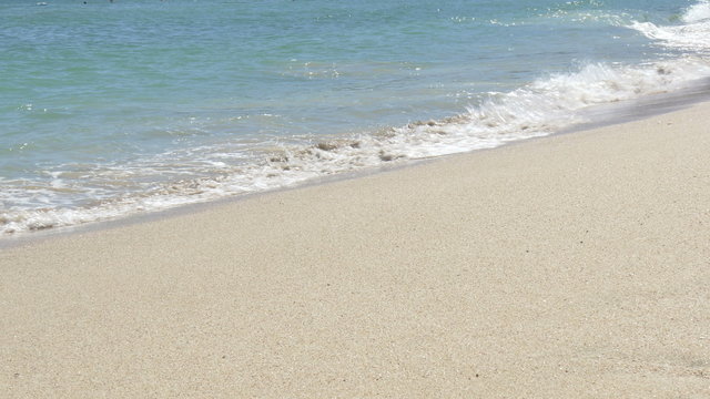 Peaceful waves approaching the white, sandy beach of Ohama.