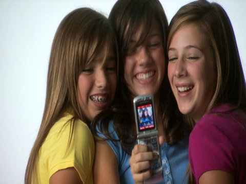 Three tweens with cell phones