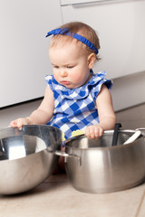 Little cute girl playing in kitchen