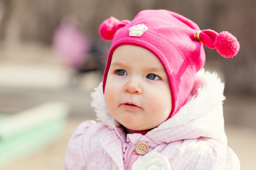 Portrait cute happy baby girl in hat in summer park,