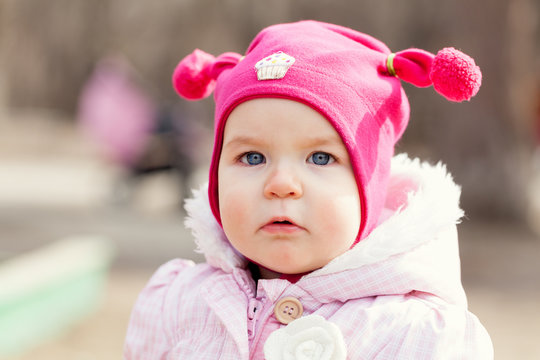 Portrait cute happy baby girl in hat in summer park,