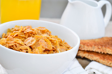 Breakfast cereal with toast and juice.
