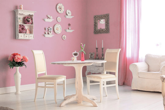dining room interior with flowers decorative plates pink wall an
