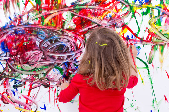 Young Kid Painting Abstract on White Wall