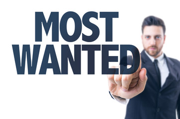 Business man pointing the text: Most Wanted