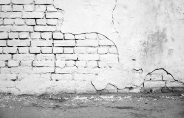 Interior, white damaged brick wall and asphalt