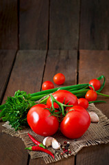 Branch of fresh tomato on wooden background