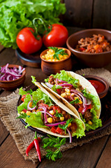 Mexican tacos with meat, vegetables and red onion