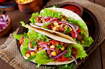 Mexican tacos with meat, vegetables and red onion