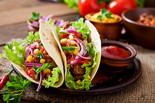 Mexican tacos with meat, vegetables and red onion