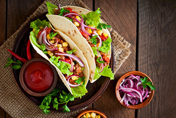 Mexican tacos with meat, vegetables and red onion