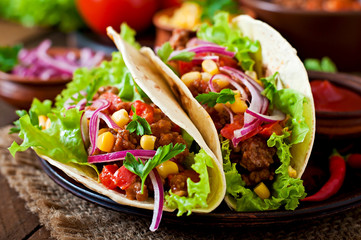 Mexican tacos with meat, vegetables and red onion